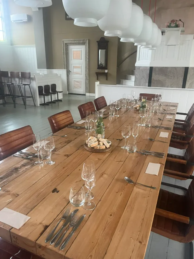 Lange gedekte tafel met wijnglazen, klaar voor het diner